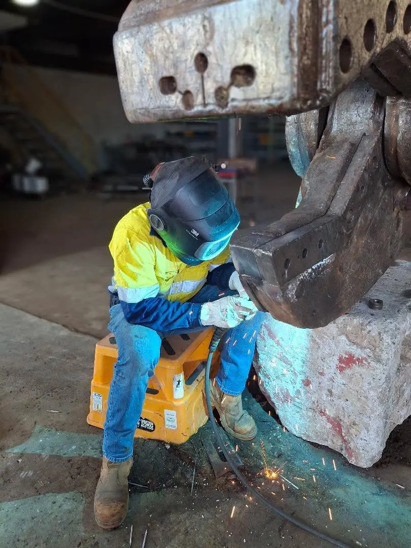 Boilermaker repairing a heavy equipment attachment