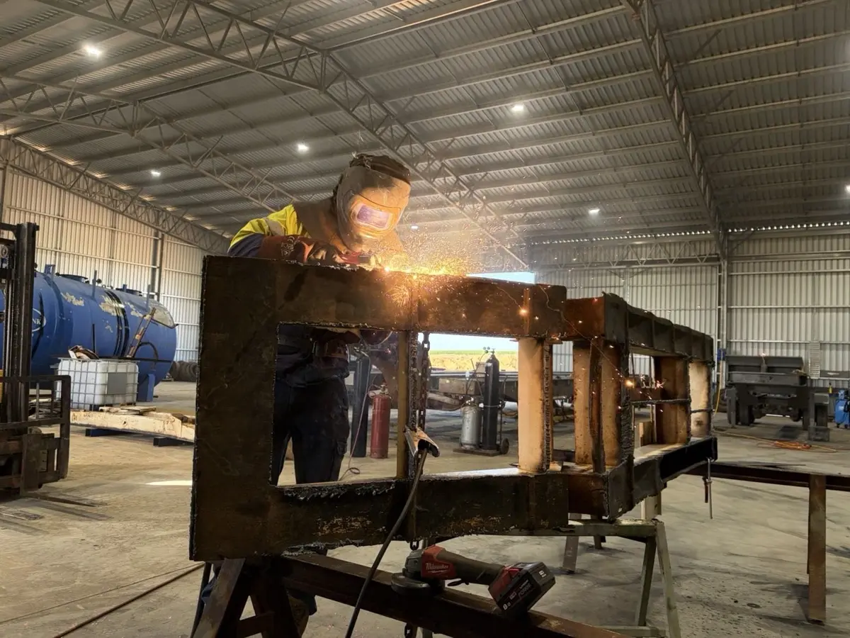 Welding a heavy steel frame with sparks flying