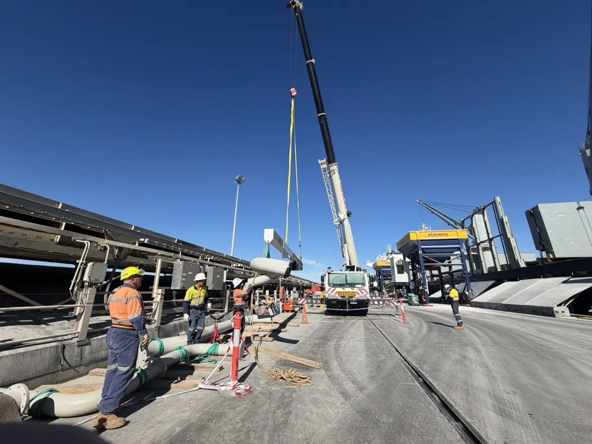 Crane lifting a pipe spool into place at the port